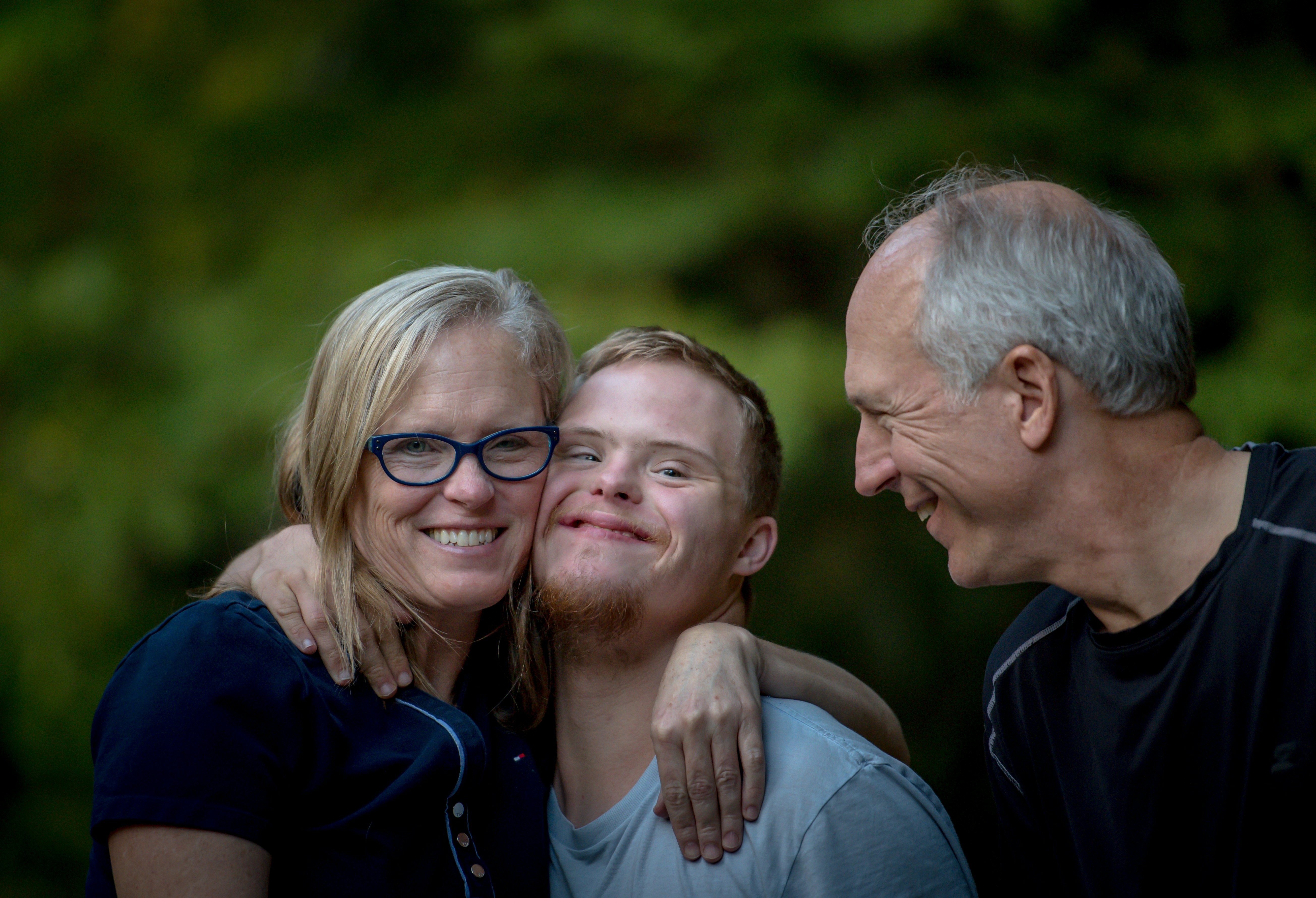 A family sharing a warm embrace outdoors
